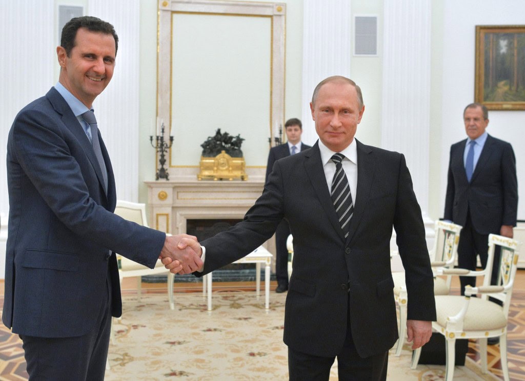 Russian President Vladimir Putin (R) shakes hands with his Syrian counterpart Bashar al-Assad (L) during a meeting at the Kremlin in Moscow on October 20, 2015. Assad, on his first foreign visit since Syria's war broke out, told his main backer and counterpart Putin in Moscow that Russia's campaign in Syria has helped contain "terrorism". AFP PHOTO / RIA NOVOSTI / KREMLIN POOL / ALEXEY DRUZHININ (Photo credit should read ALEXEY DRUZHININ/AFP/Getty Images)